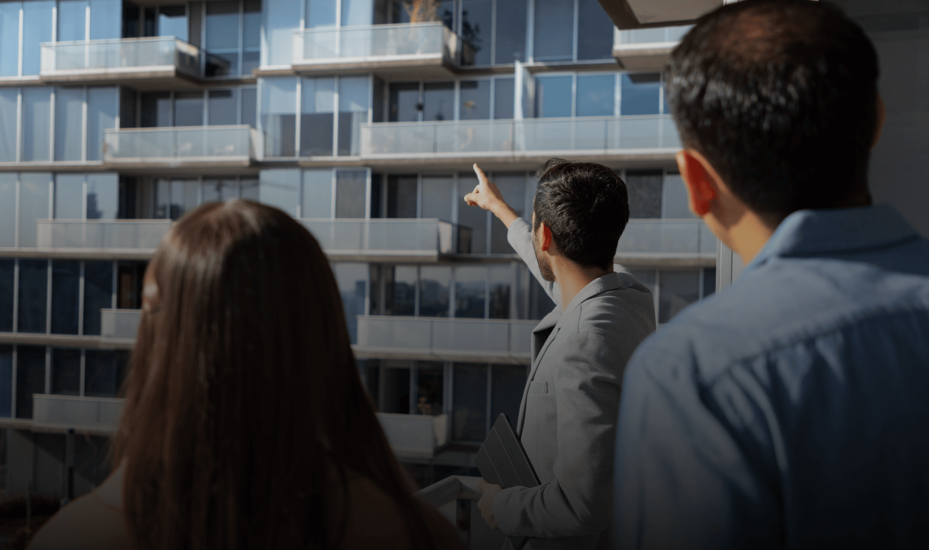 Hands holding holographic city buildings