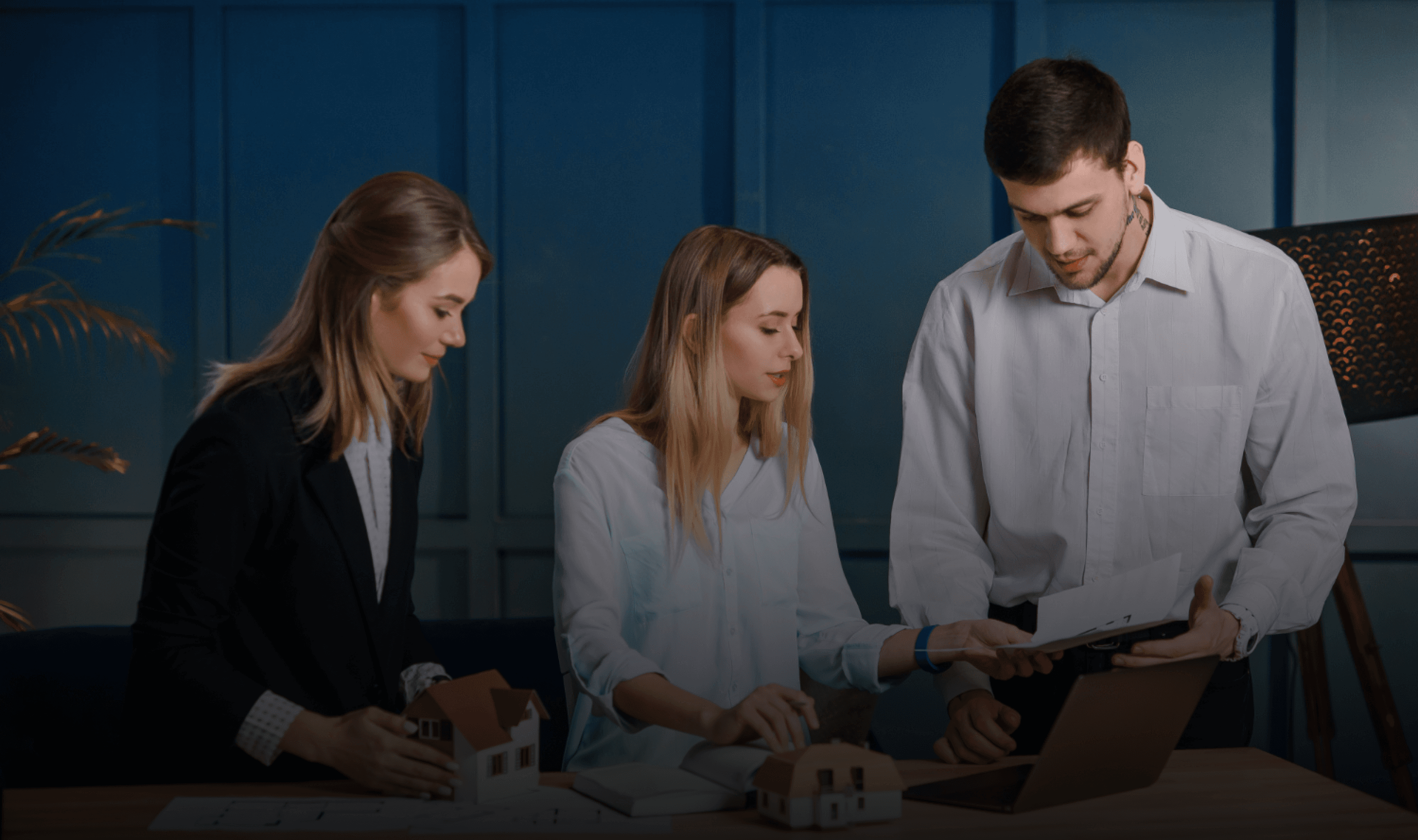 Hands holding holographic city buildings