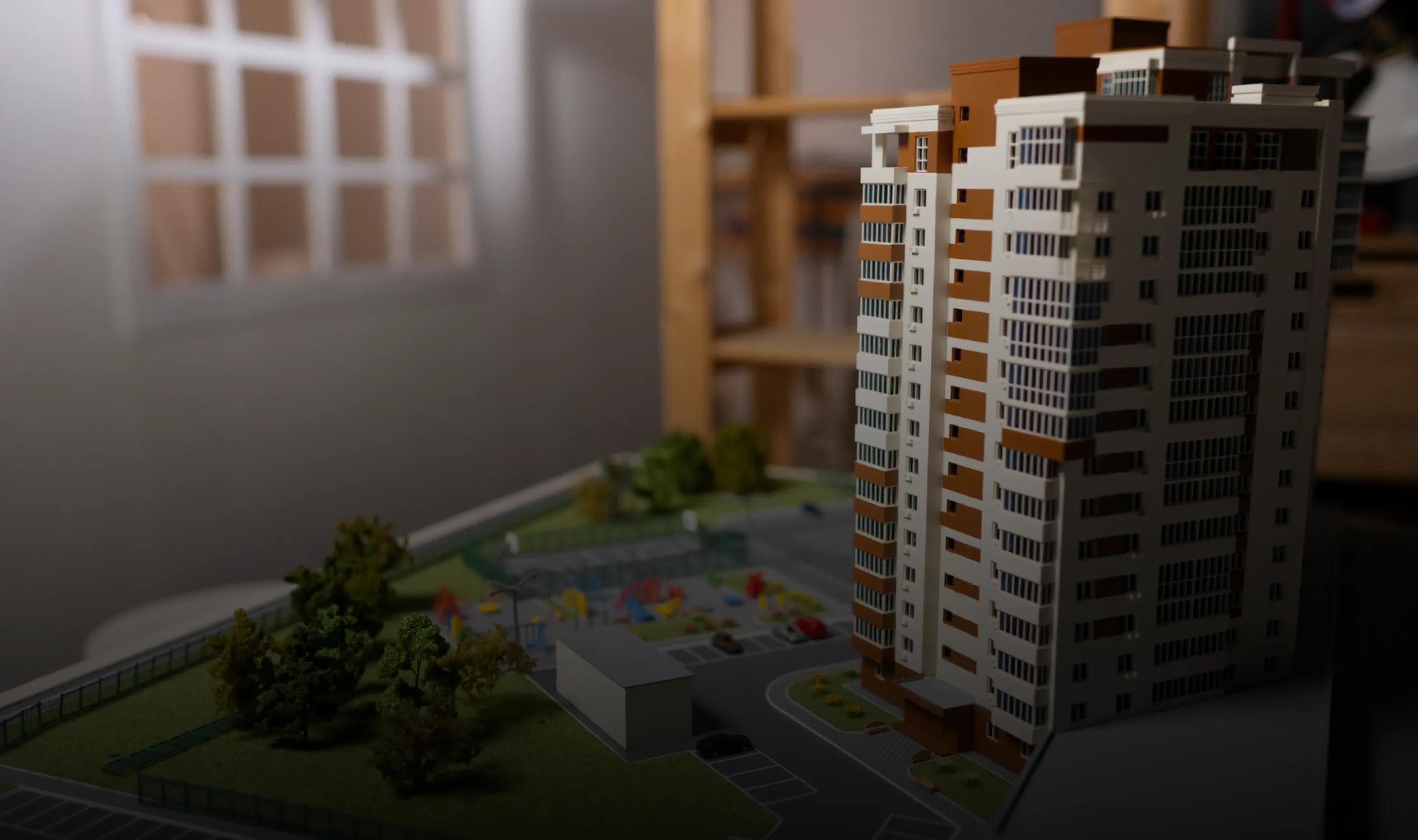 Hands holding holographic city buildings