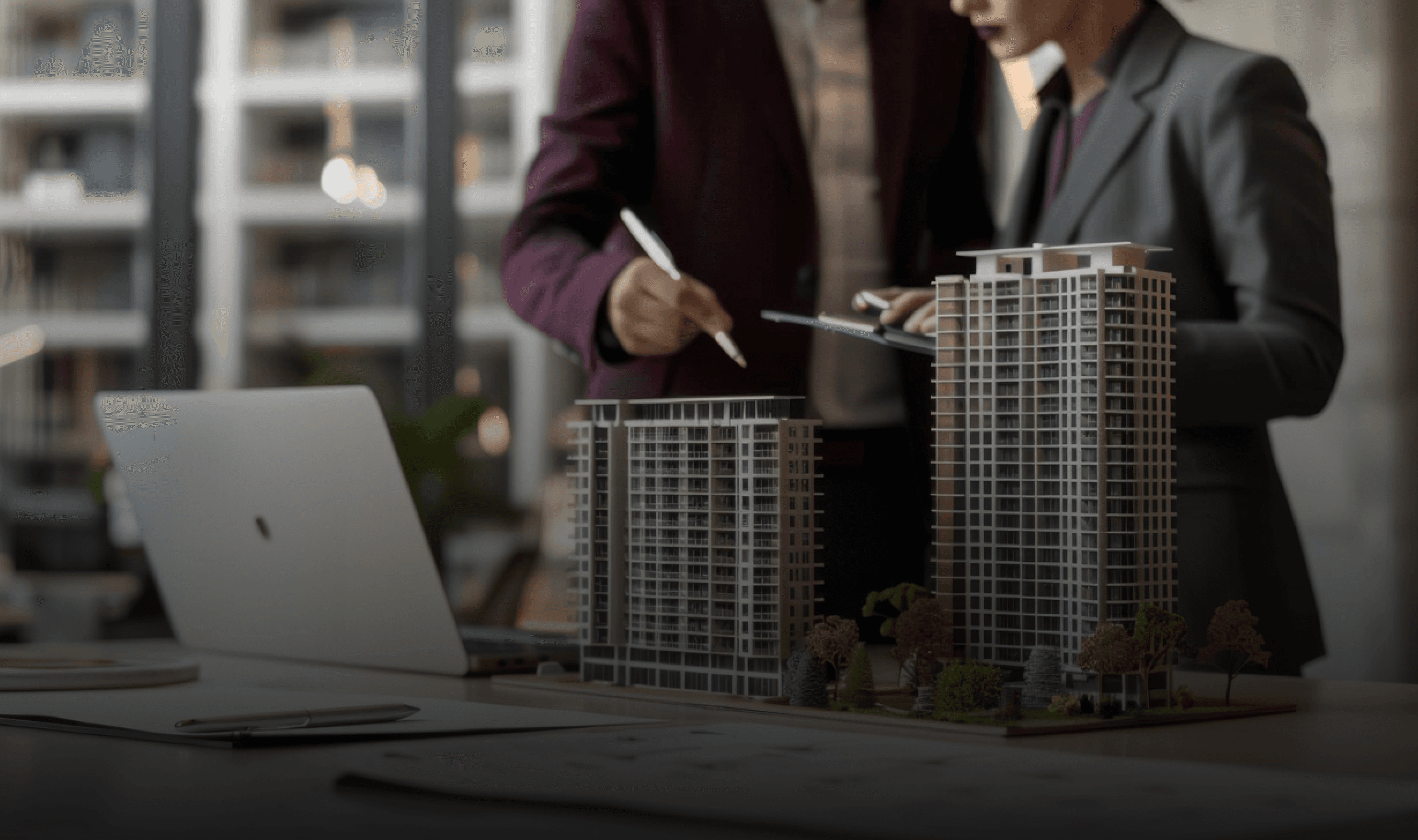 Hands holding holographic city buildings